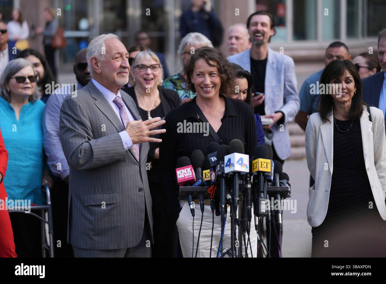 Attorney Mark Geragos, left, speaks in front of family and supporters