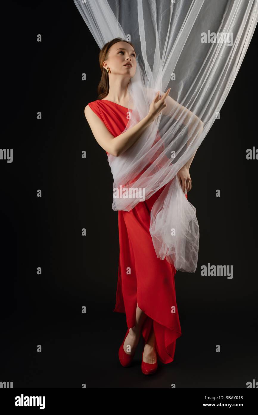 Woman poses elegantly in a studio setting, showcasing a blend of ...