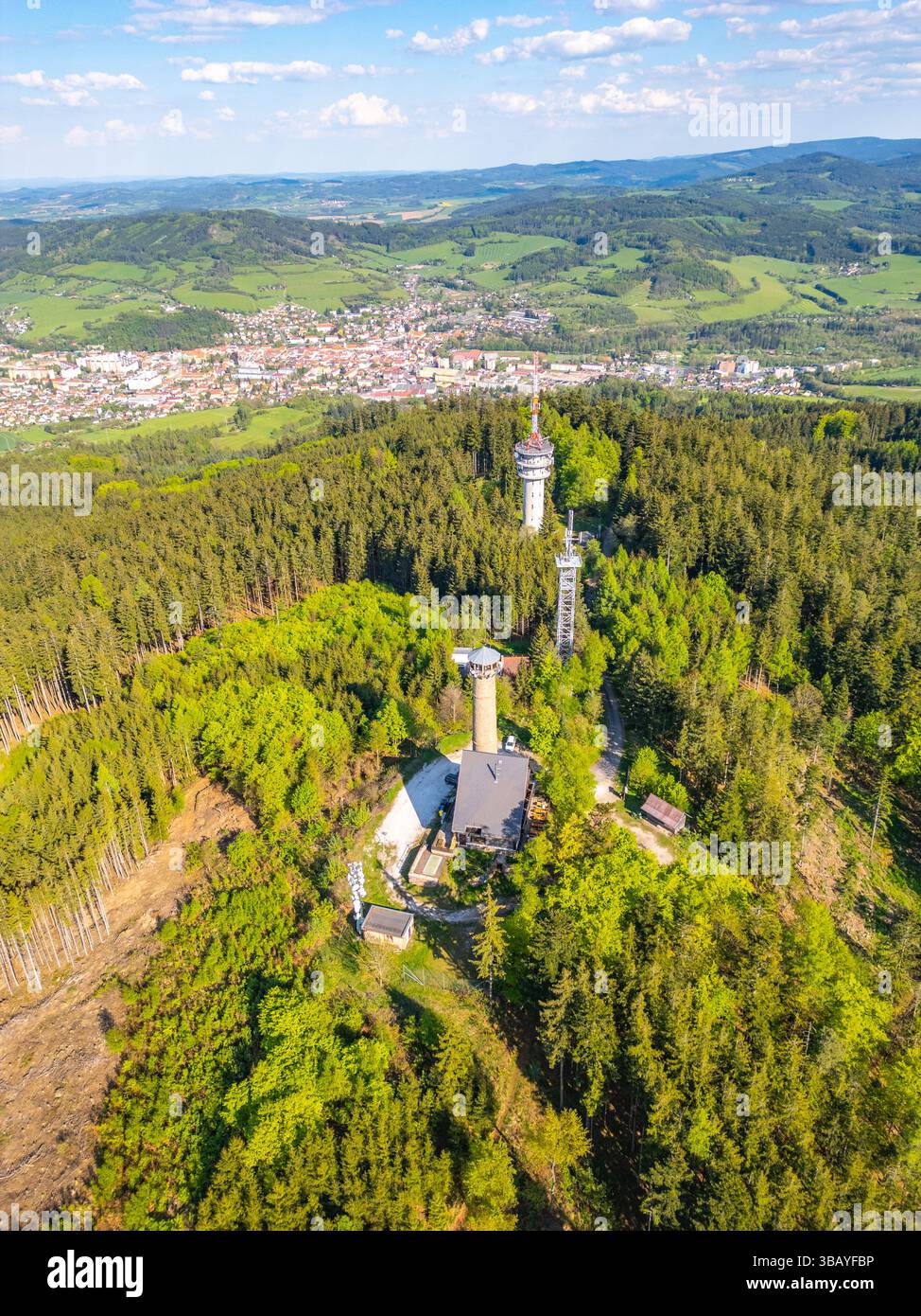The aerial view captures Svatobor Lookout Tower nestled in lush ...