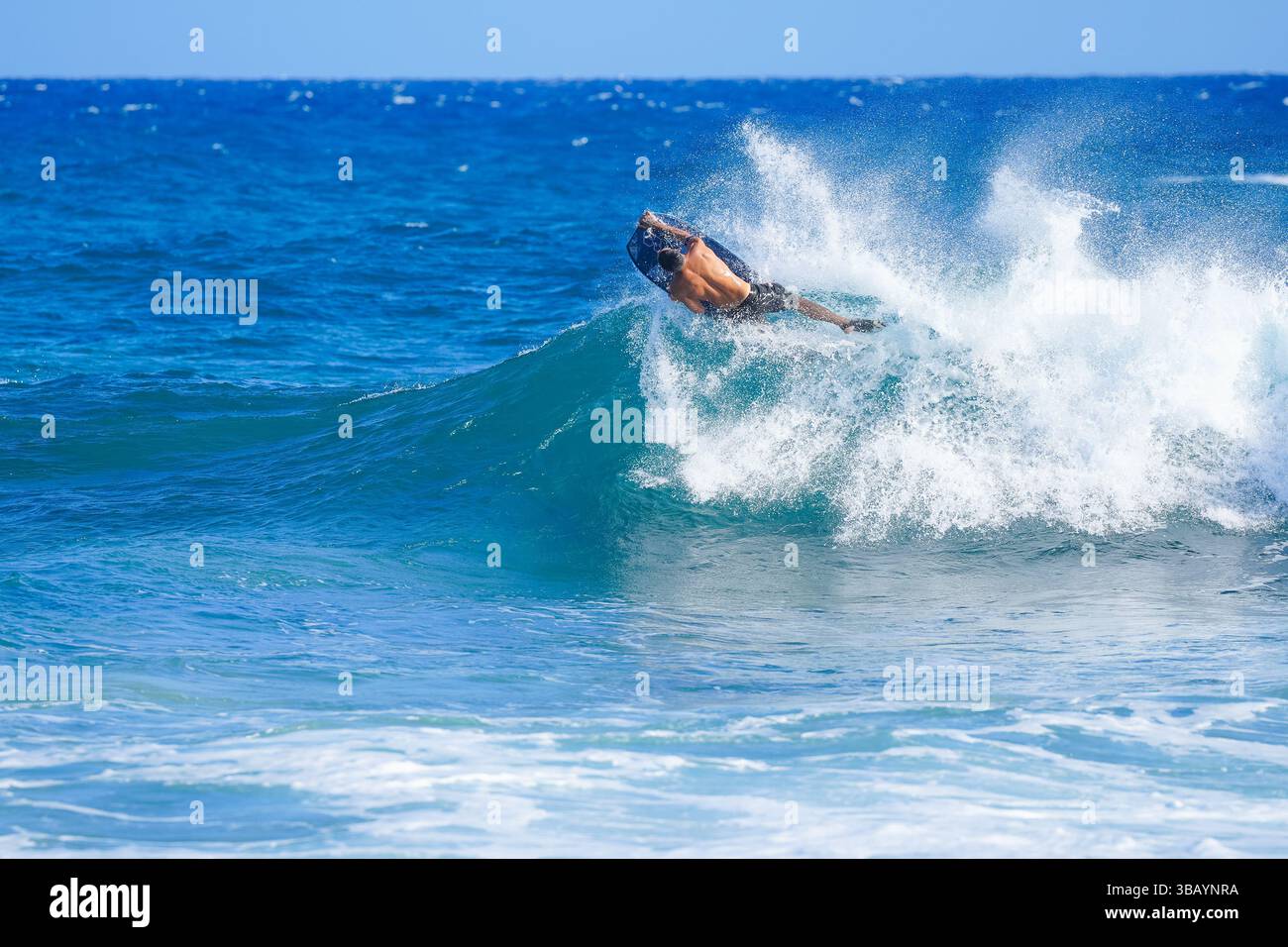 Bodyboarder performs skill flip and roll in powerful wave, creating a ...