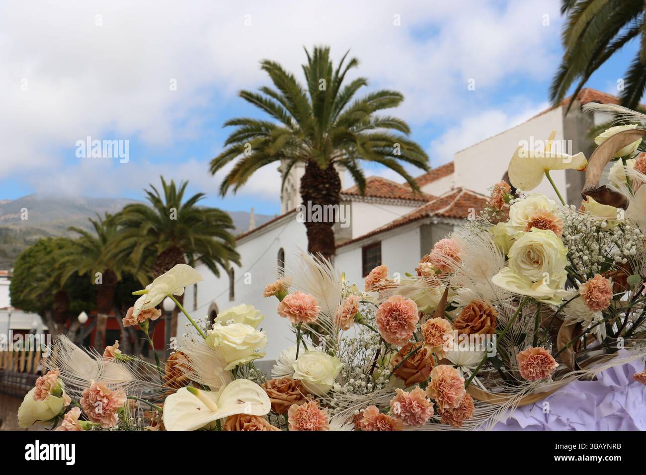 side view of the church of Guía de Isora in Tenerife next to a floral ...