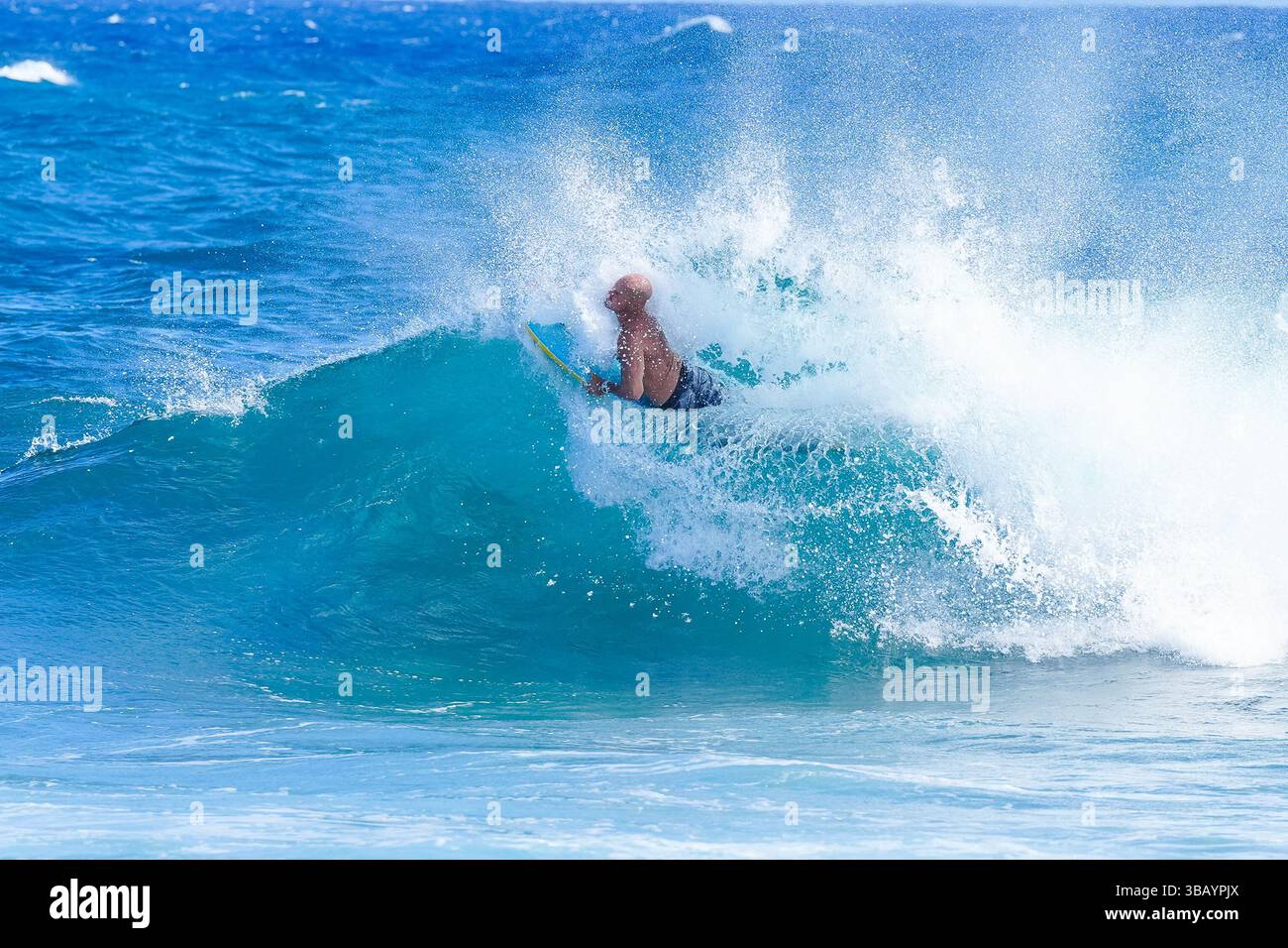Bodyboarder performs skill flip and roll in powerful wave, creating a ...