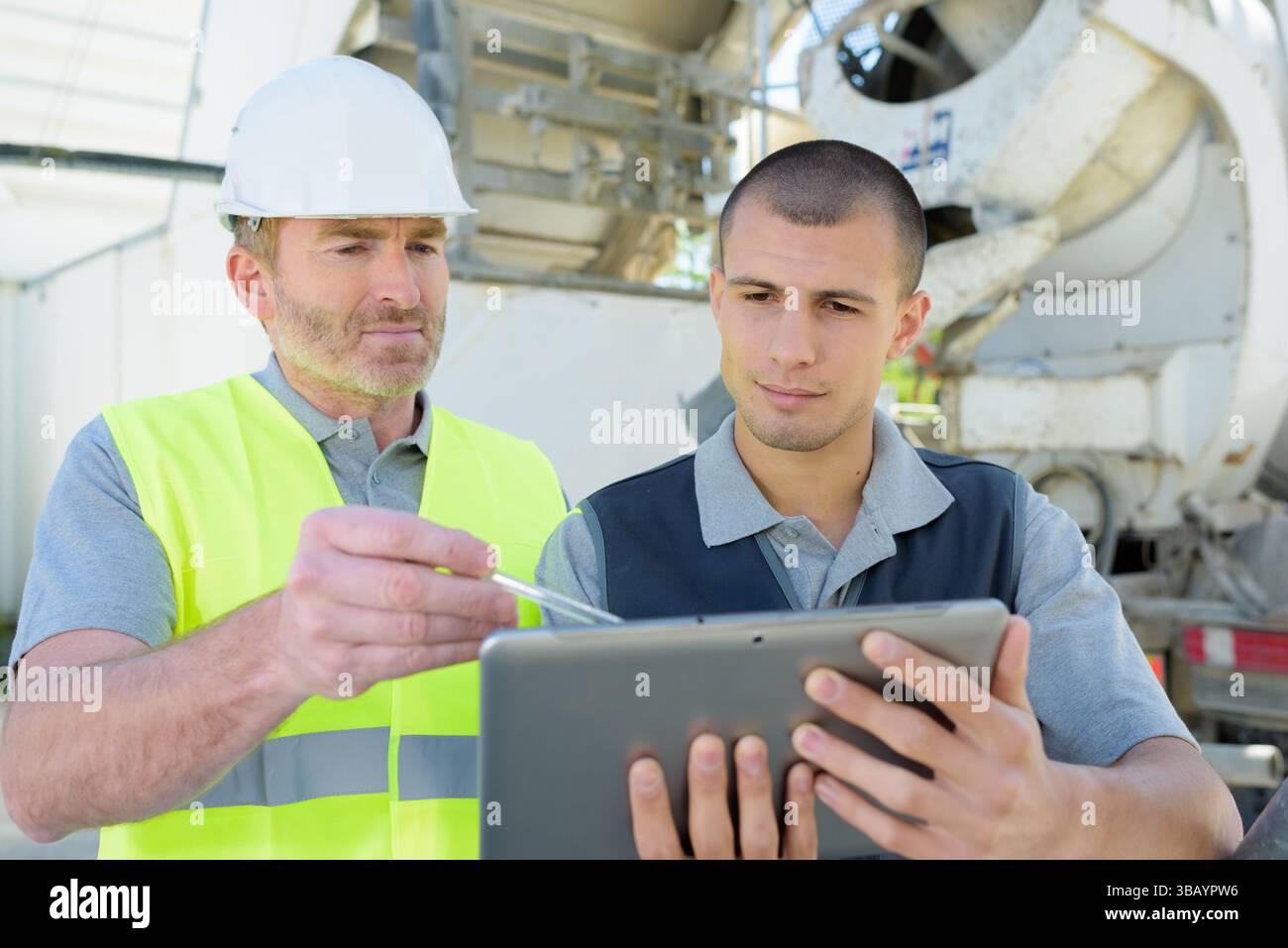two engineers in hardhat is using a tablet computer Stock Photo
