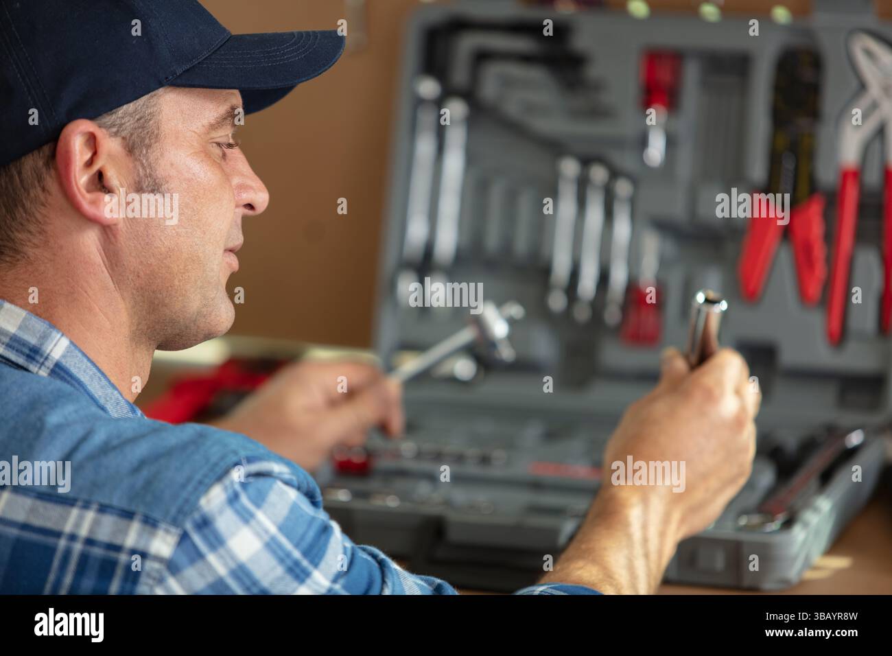 handyman searching tools in toolbox Stock Photo
