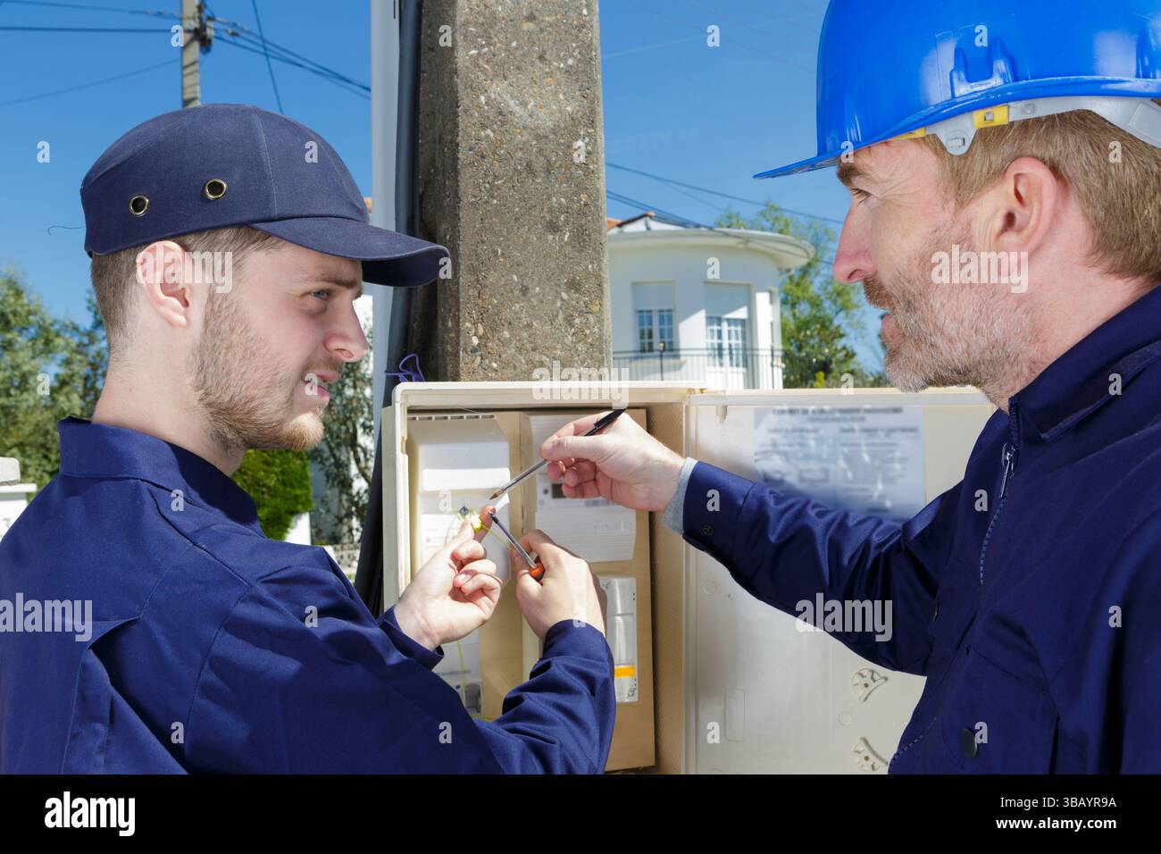 electrician builder engineer checking data from control panel Stock Photo
