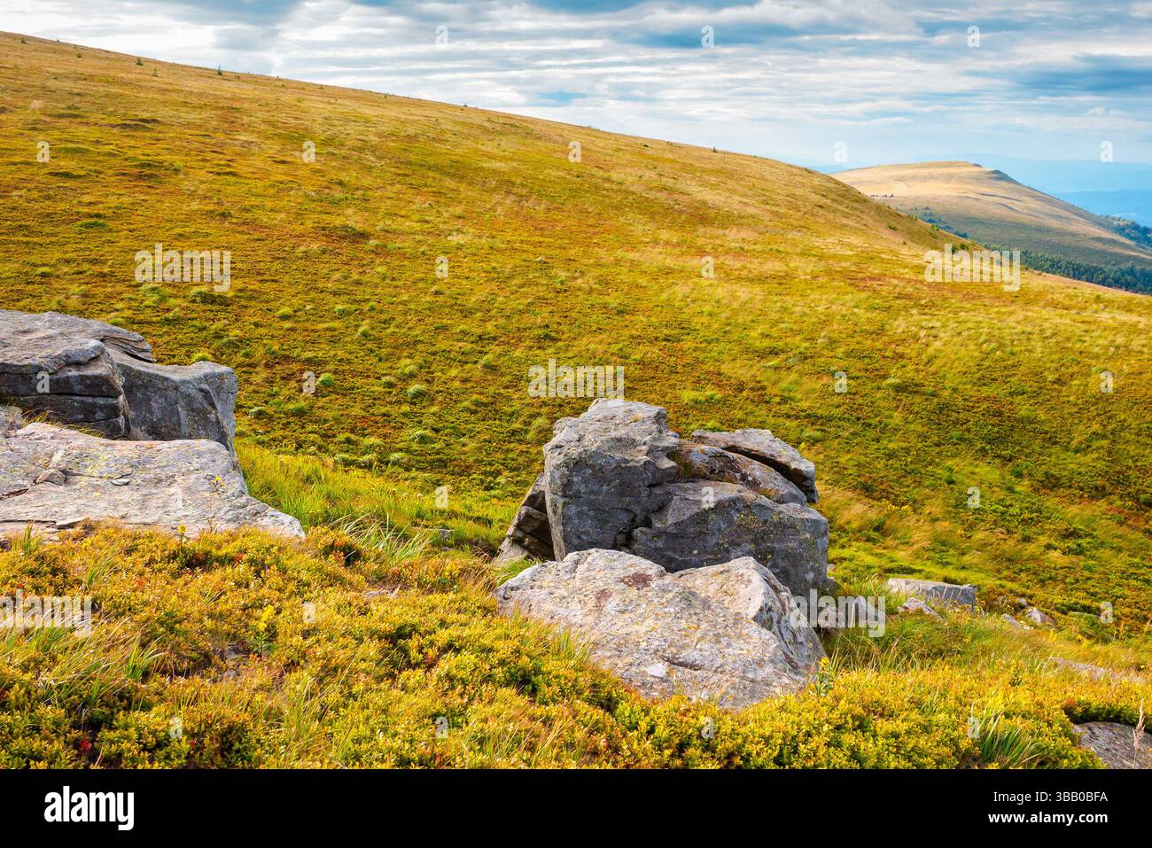 beautiful mountain landscape in late summer. colorful alps with large stones on the hill in august. dramatic sky with grey clouds. end of vacation sea Stock Photo