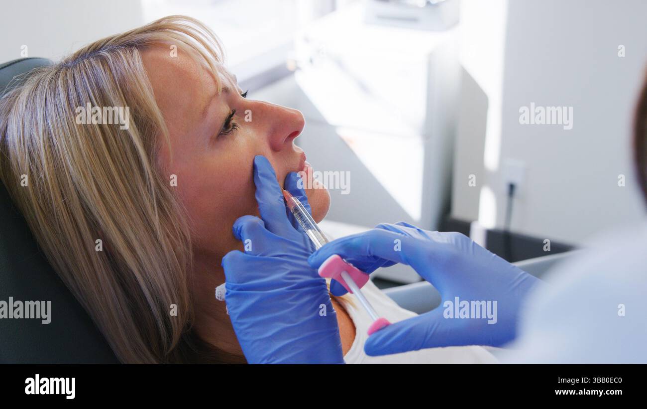 Mature Woman Sitting In Chair Being Give Botox Injection By Female ...