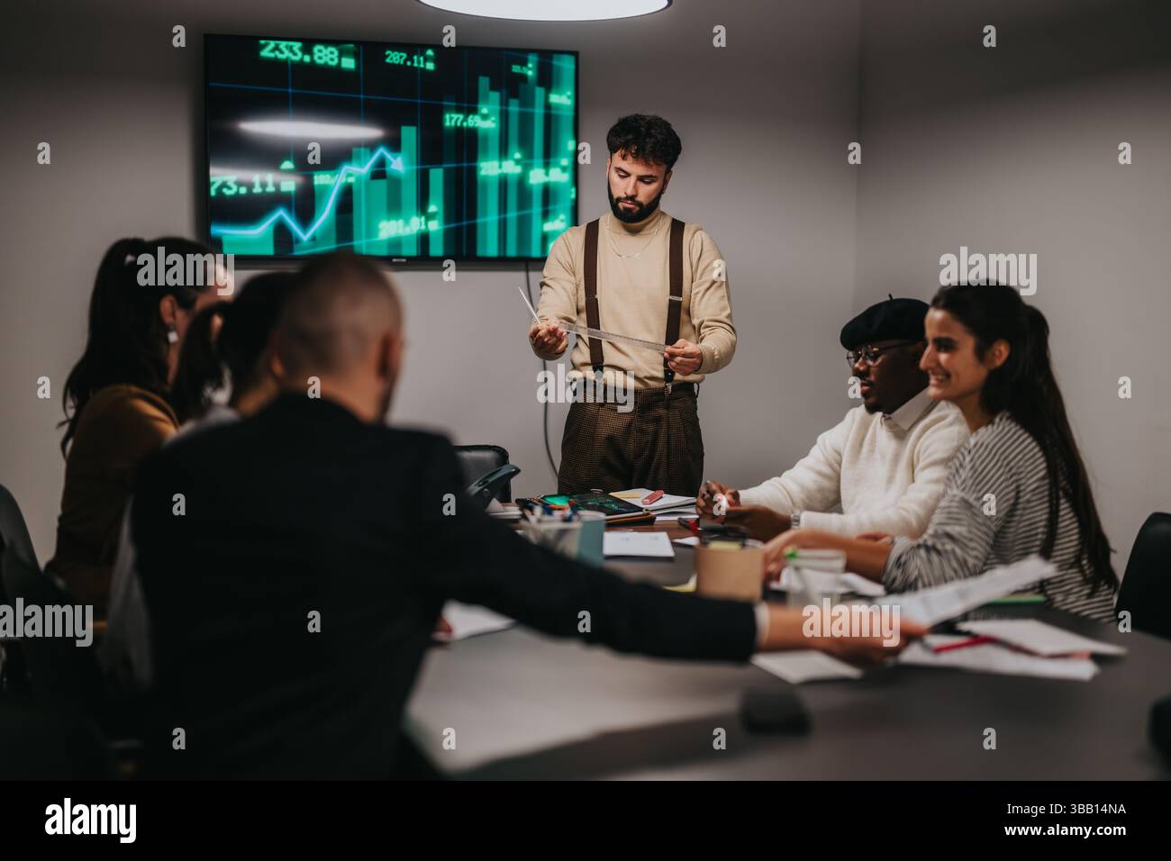 Team Collaborating During a Business Strategy Meeting with Data Visualization Stock Photo