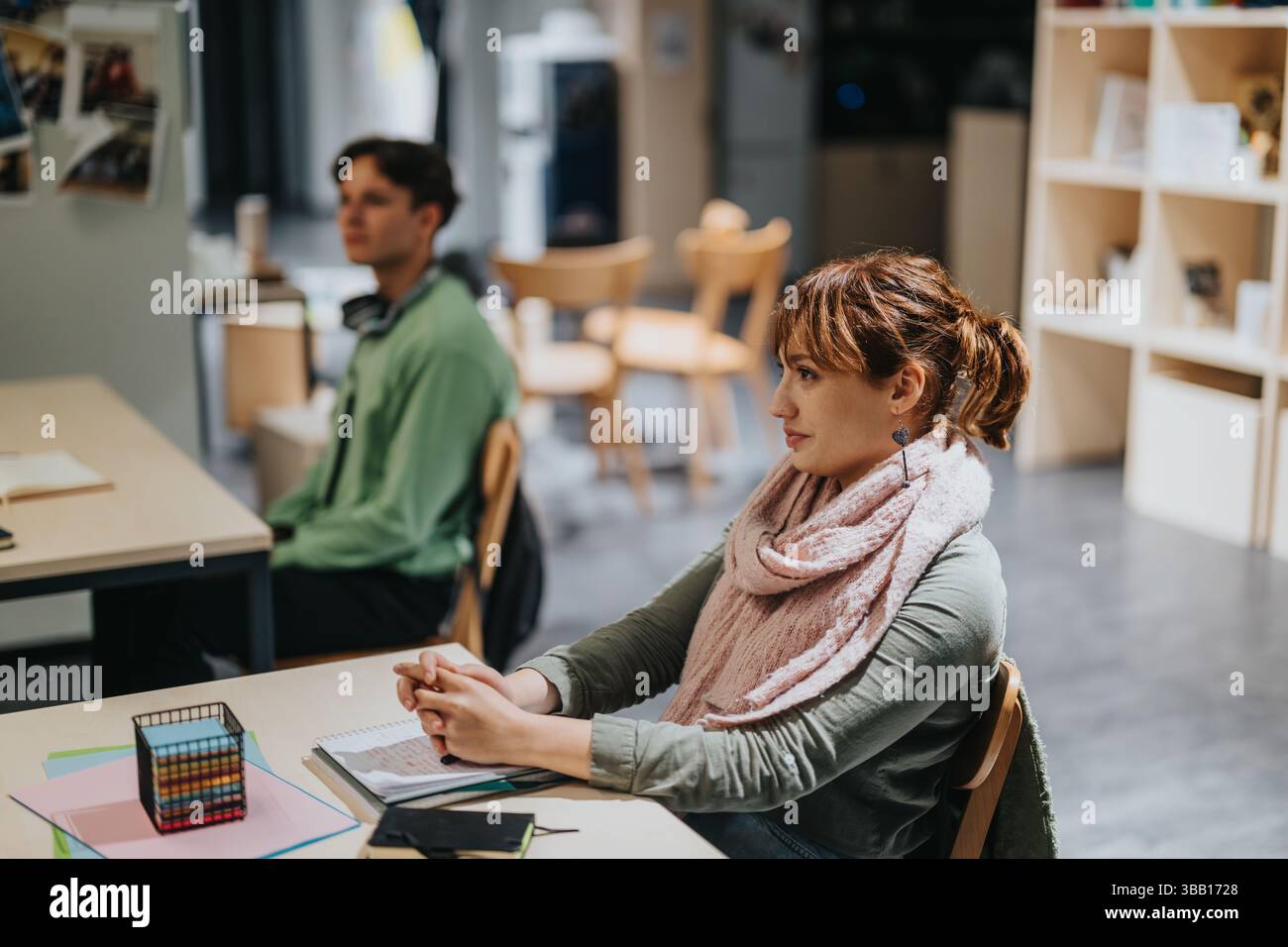 Engaged students in classroom with attentive elderly professor Stock Photo