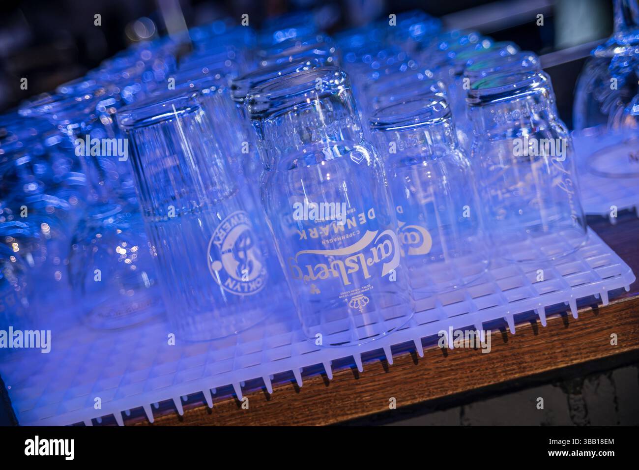 Rome, italy 4 may 2025: empty carlsberg beer glasses are drying upside ...