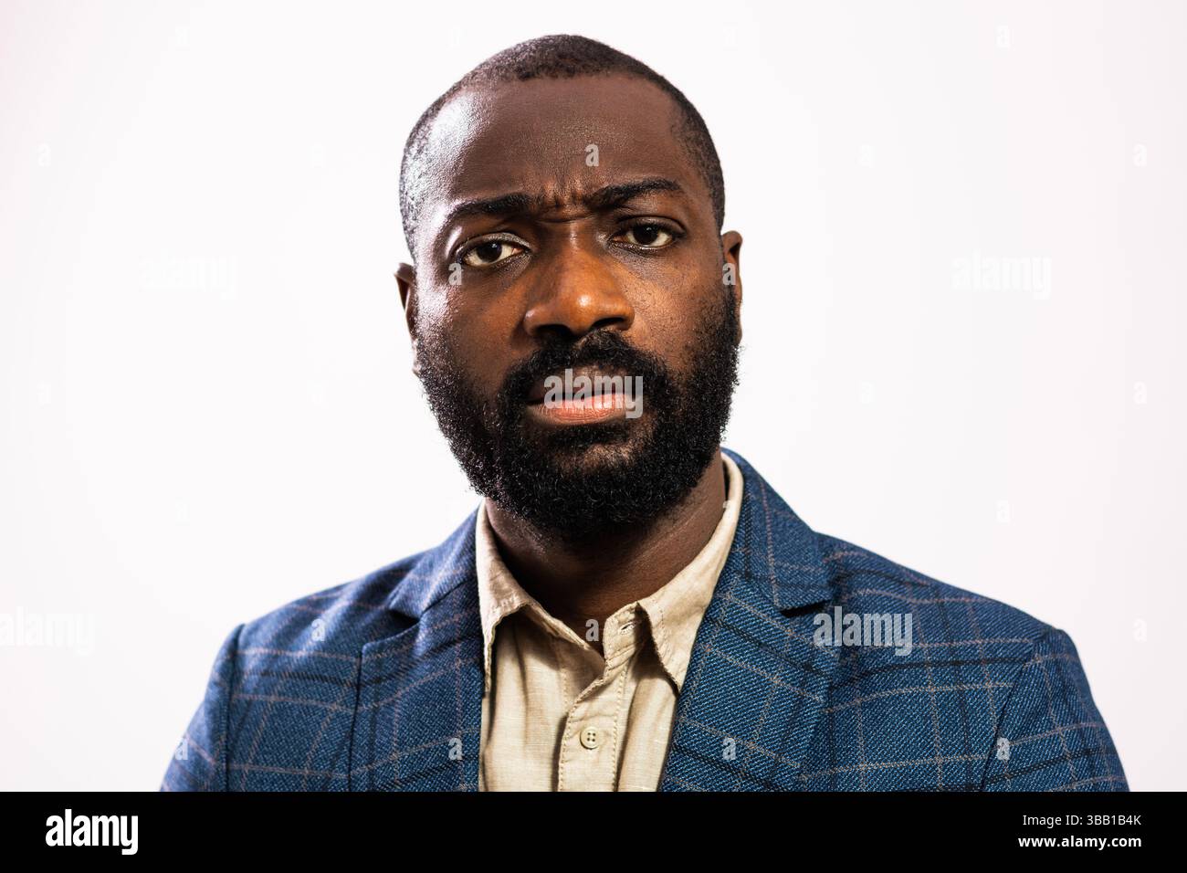 Close up portrait of worried and thoughtful businessman. Black man in business suit is standing and thinking. Stock Photo