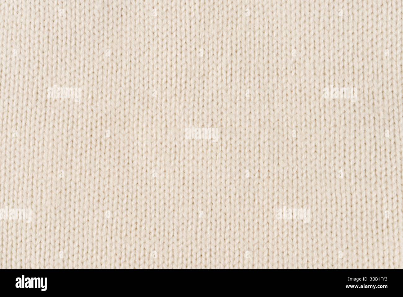 Background made of white knitted fabric. Front surface. Stock Photo