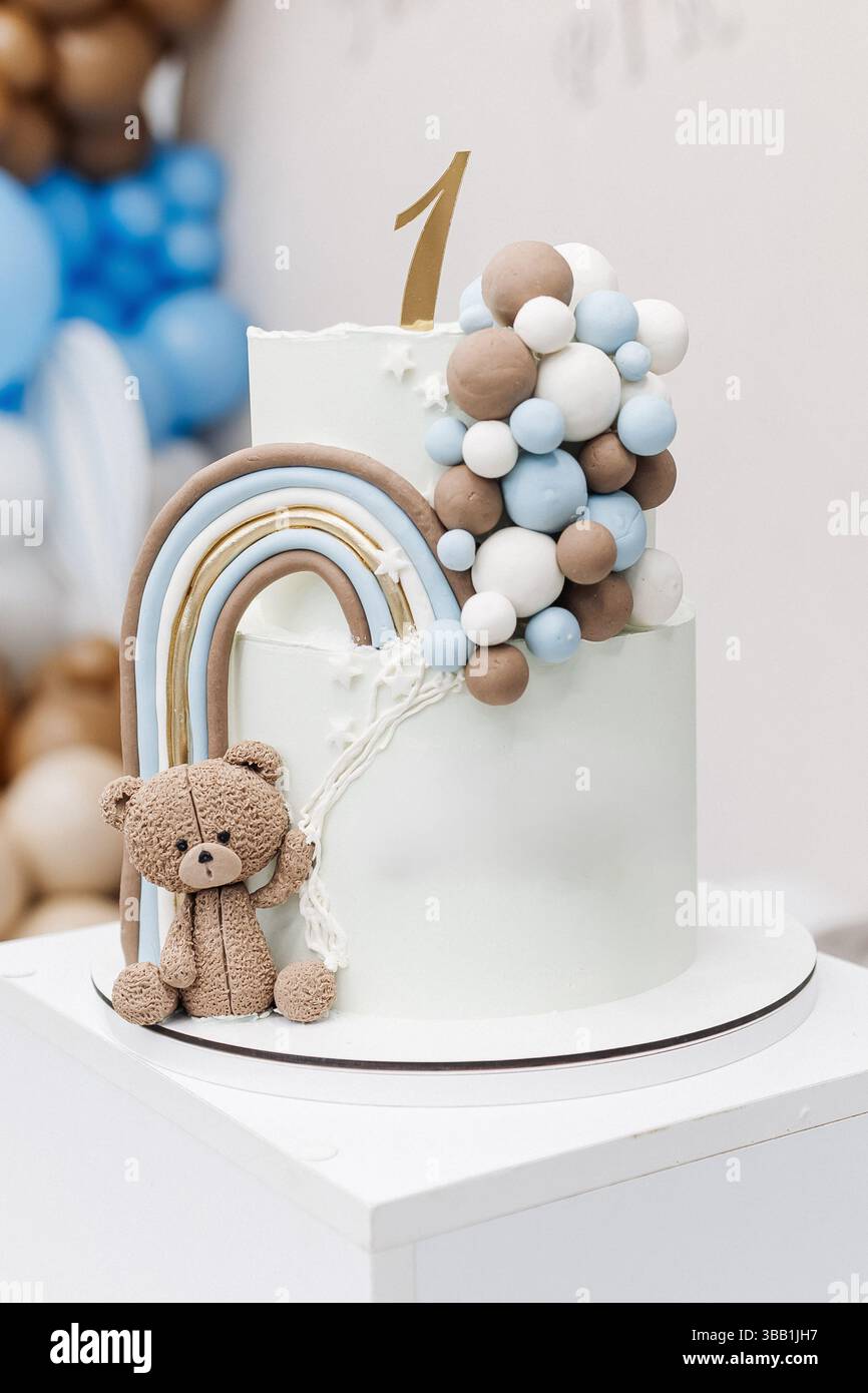 Two-story sweet cake decorated with a teddy bear for a birthday ...