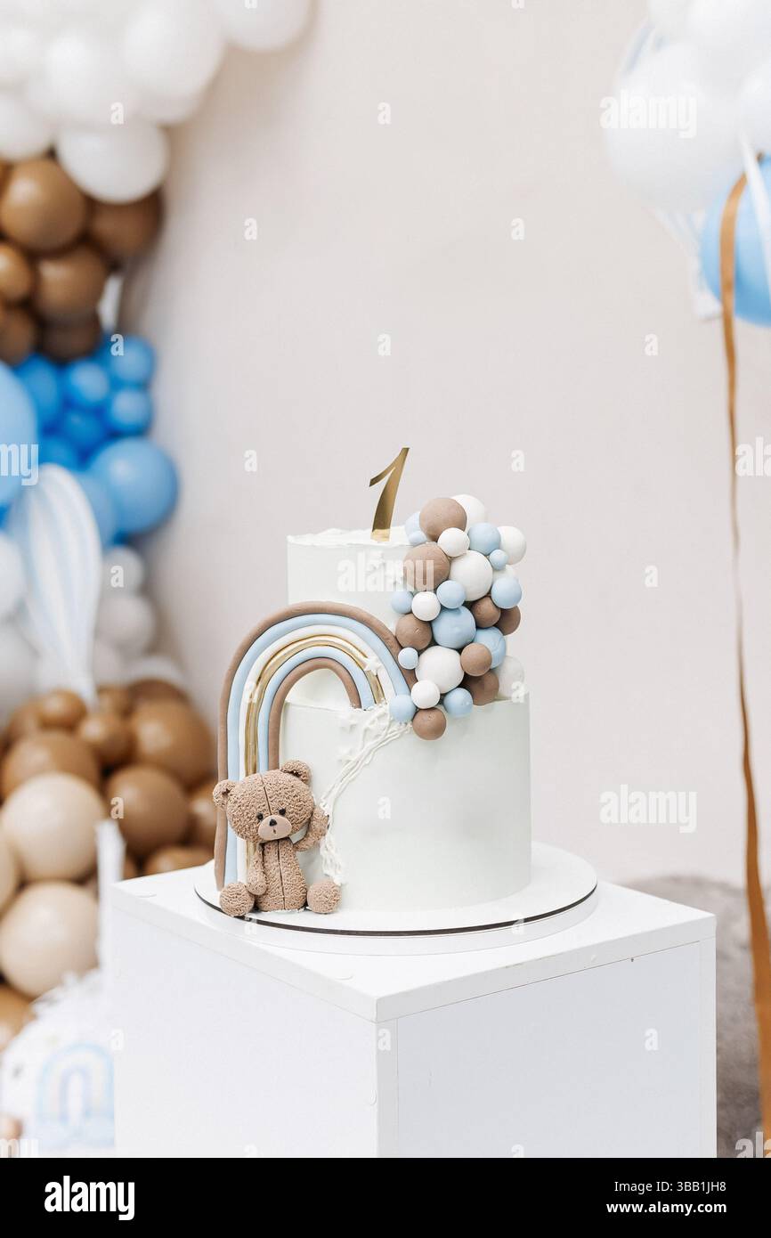 Two-story sweet cake decorated with a teddy bear for a birthday ...