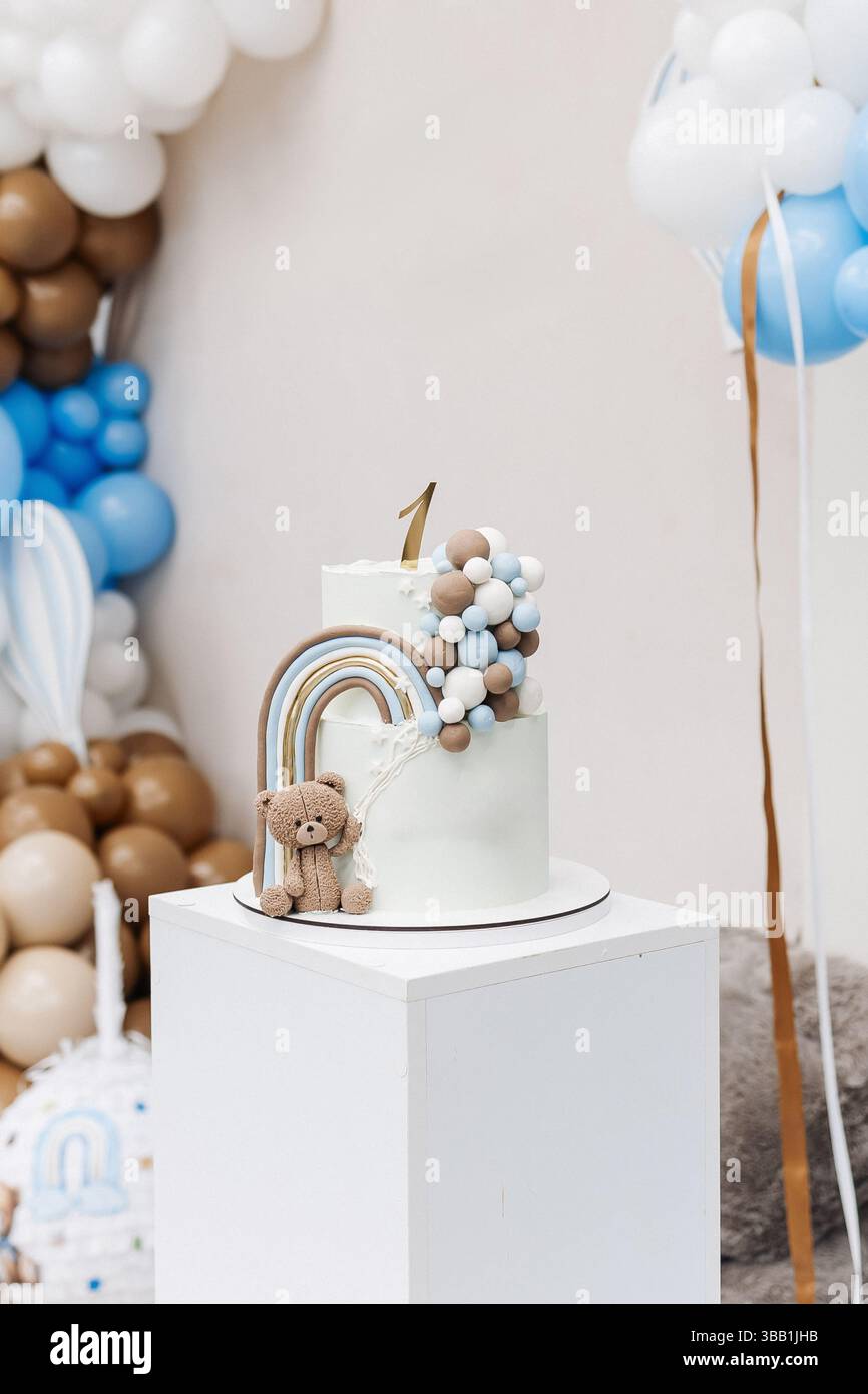 Two-story sweet cake decorated with a teddy bear for a birthday ...