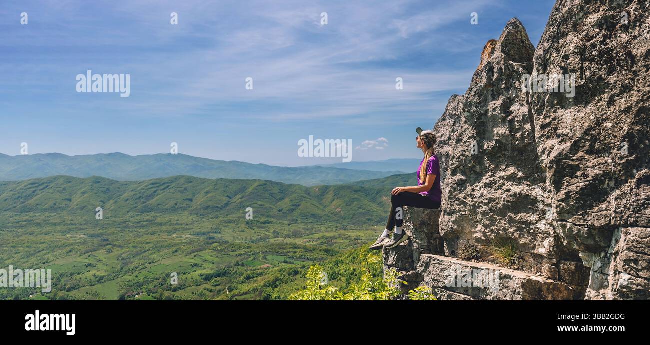 Girl sitting on edge cliff hi-res stock photography and images - Alamy