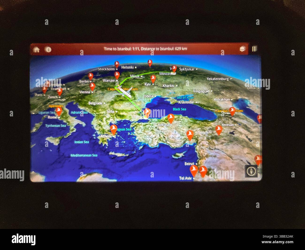 Electronic display in airplane seat, showing the big detour around Ukraine that flight from Moscow (VKO) Russia to Istanbul (IST) Türkiye has to make - Smartphone Captured Stock Image