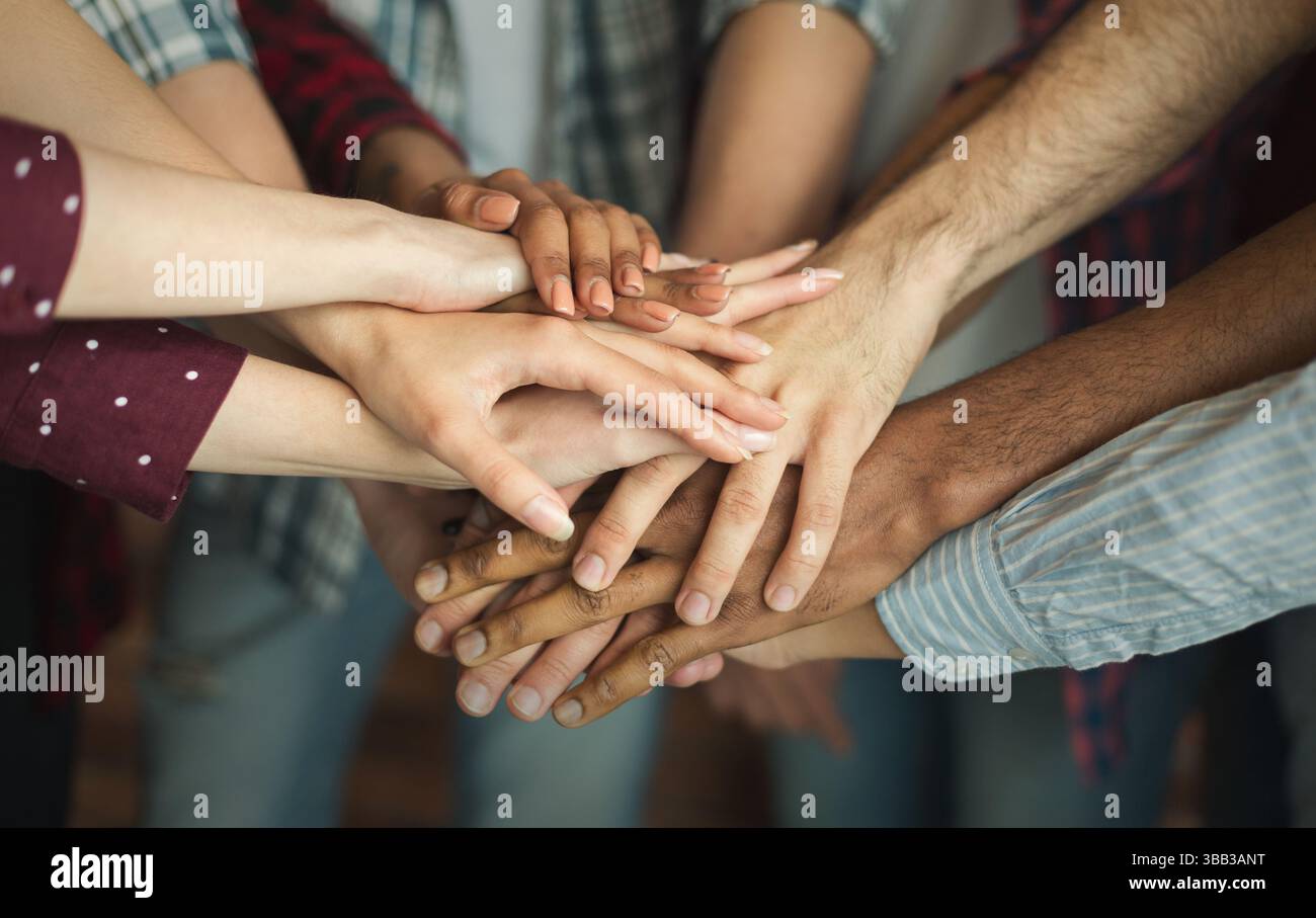Group of friends holding hands together Stock Photo - Alamy
