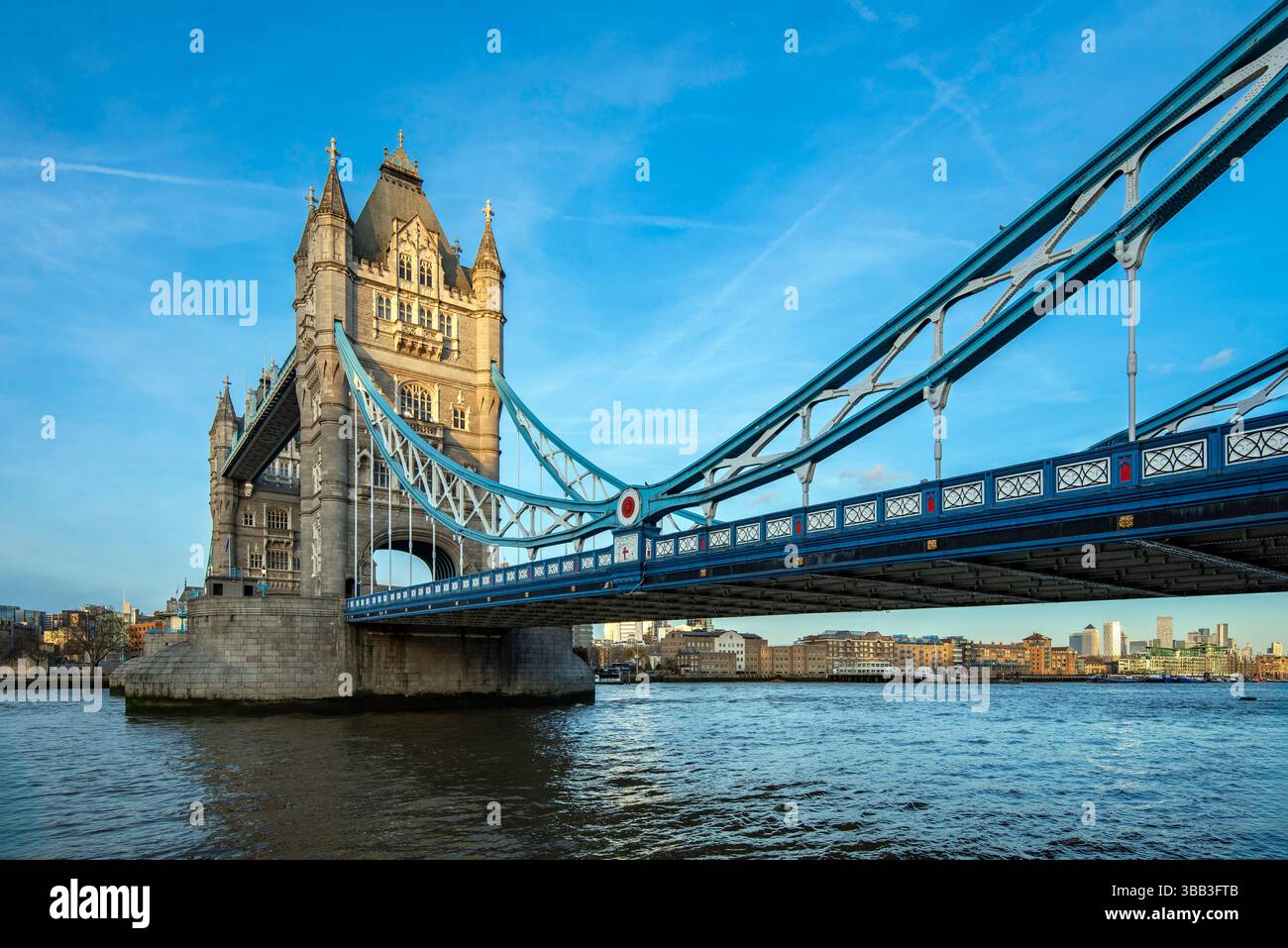 Tower Bridge in London glowing under the soft morning light, spanning the River Thames. Stock Photo