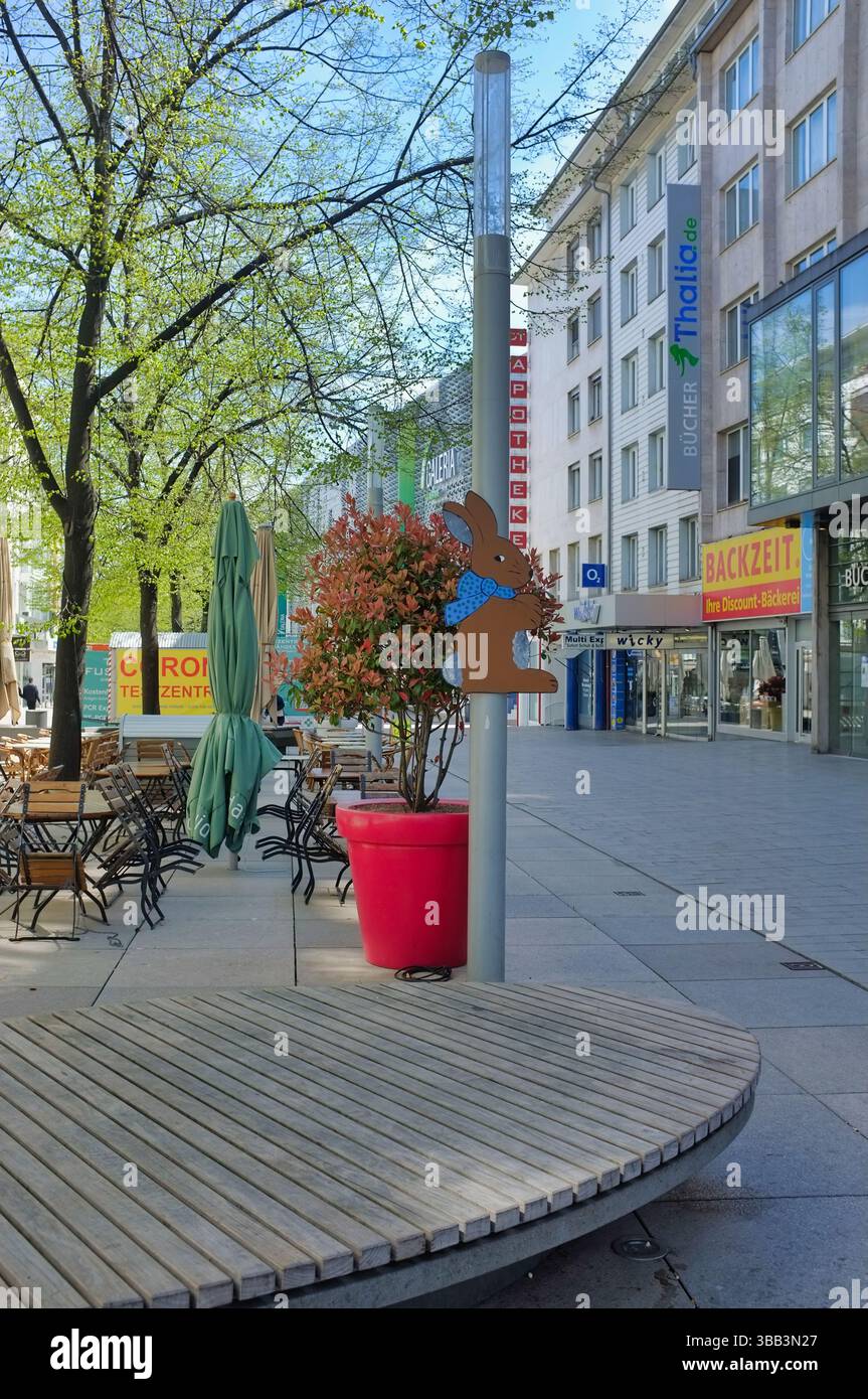 Pforzheim Germany april 12, 2022 An urban street scene featuring a storefront named Thalia.de and a cafe Stock Photo