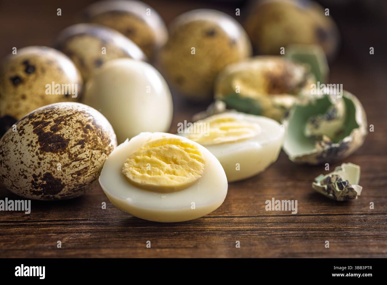 Boiled quail eggs on a wooden table. Stock Photo