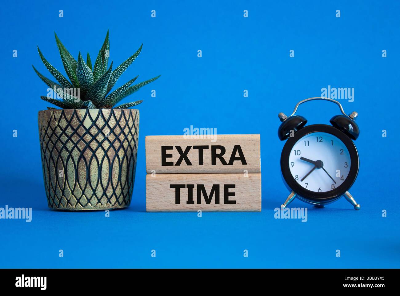 Extra time symbol. Concept word Extra time on wooden blocks. Beautiful ...