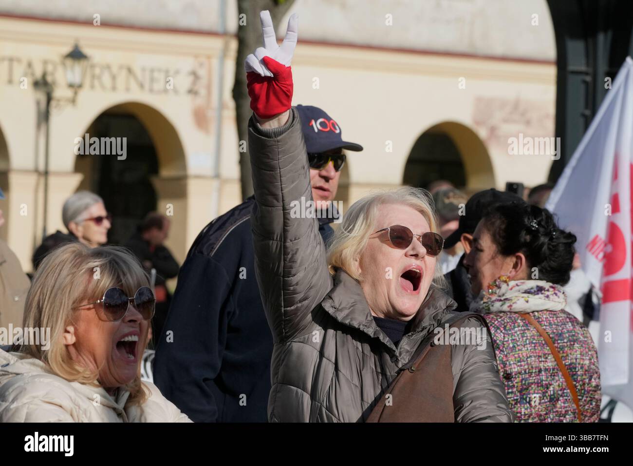 A woman makes the victory symbol at a campaign stop of Warsaw Mayor Poland Presidential Election 2025 Polymarket