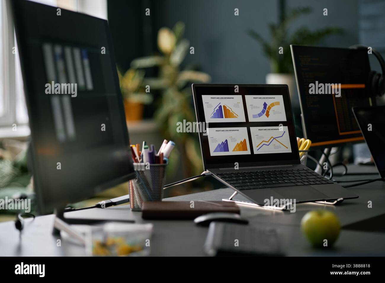Workspace with computer screens displaying various data graphs and charts. Modern office setting with a focus on technology and data analysis making i Stock Photo