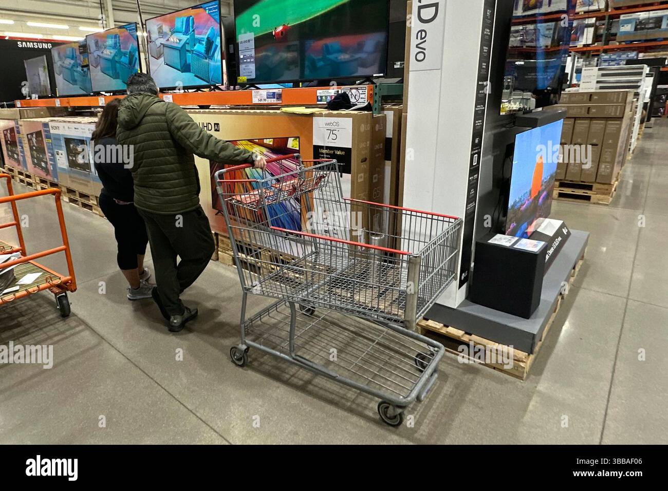 FILE - Shoppers consider big-screen televisions on display in a Costco ...