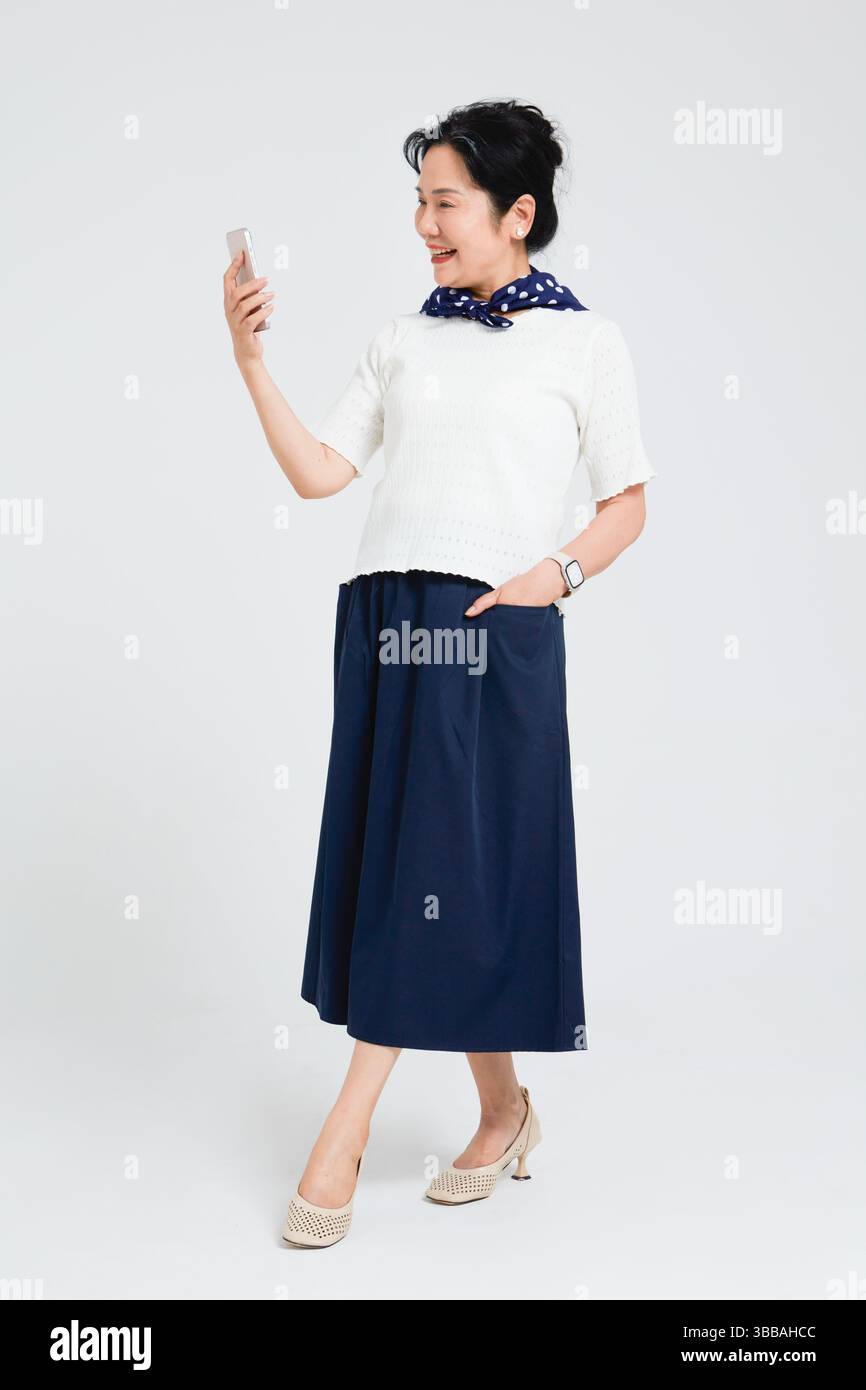 Chinese elderly women using smartphones​ Stock Photo