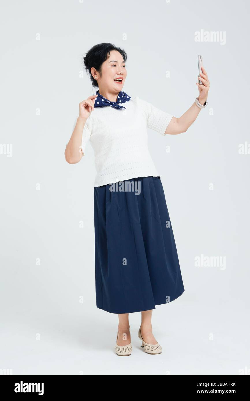 Chinese elderly women using smartphones​ Stock Photo