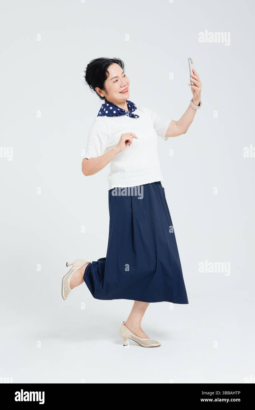 Chinese elderly women using smartphones​ Stock Photo