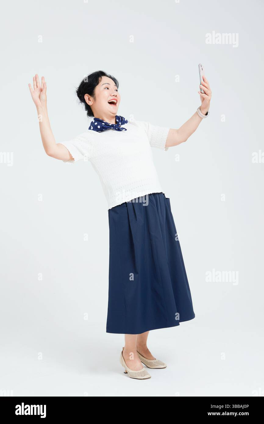 Chinese elderly women using smartphones​ Stock Photo