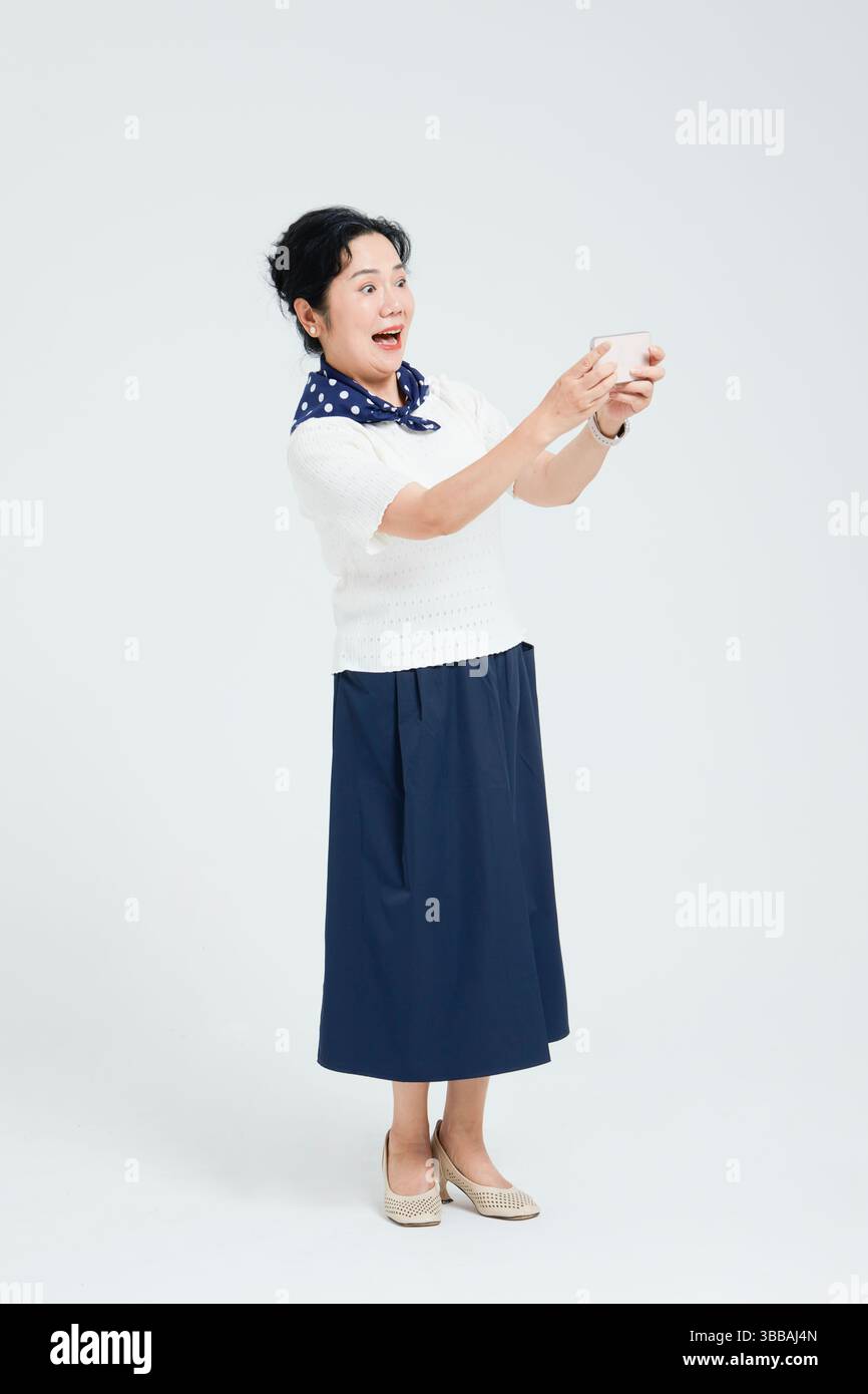 Chinese elderly women using smartphones​ Stock Photo