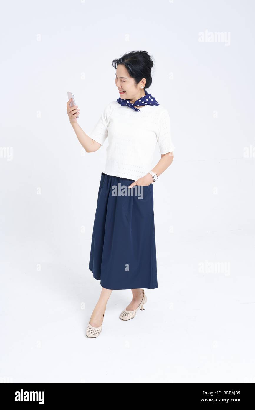 Chinese elderly women using smartphones​ Stock Photo