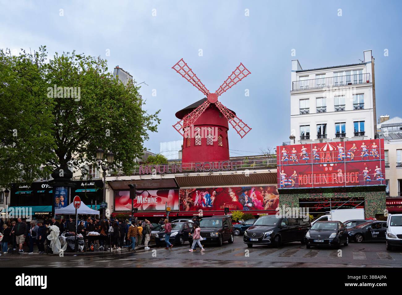 Front view of the Moulin Rouge cabaret with its iconic red windmill ...