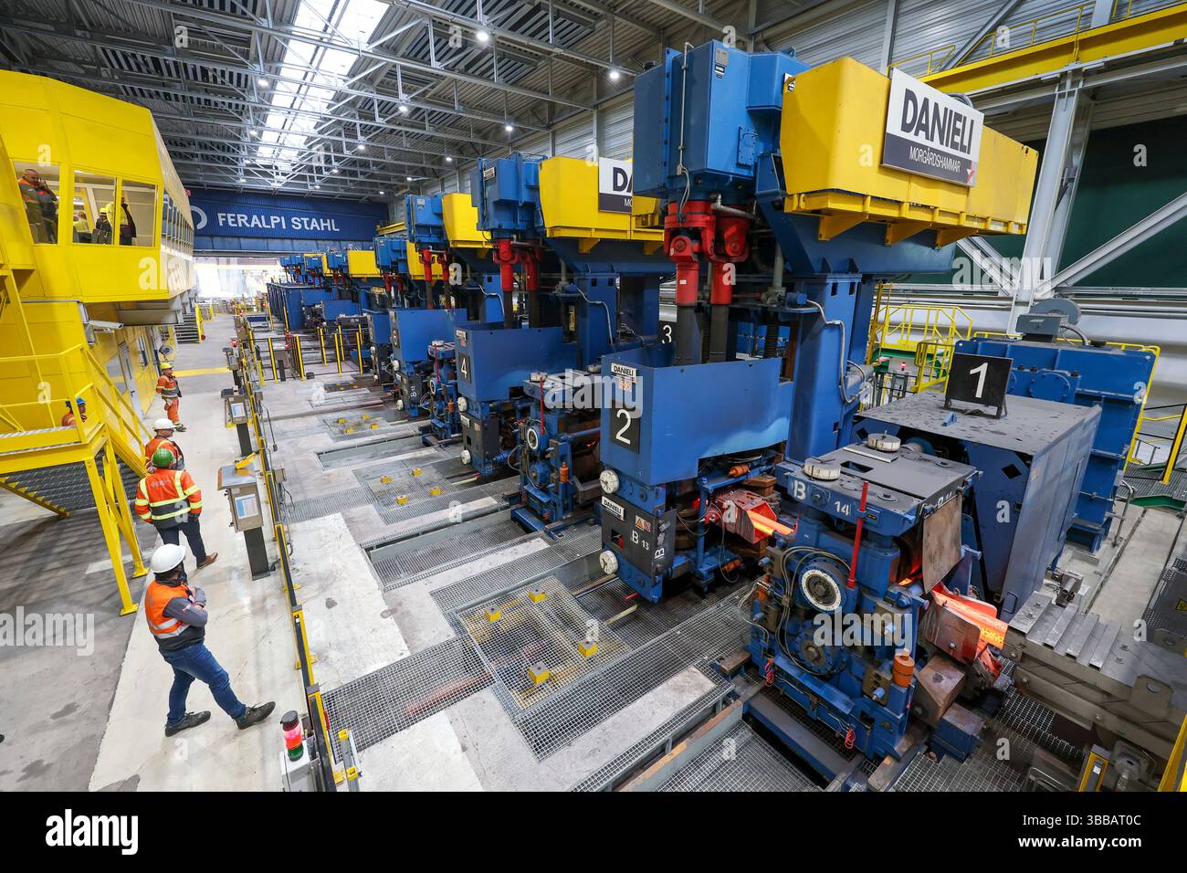 Riesa, Germany. 15th May, 2025. A still glowing billet of steel enters ...