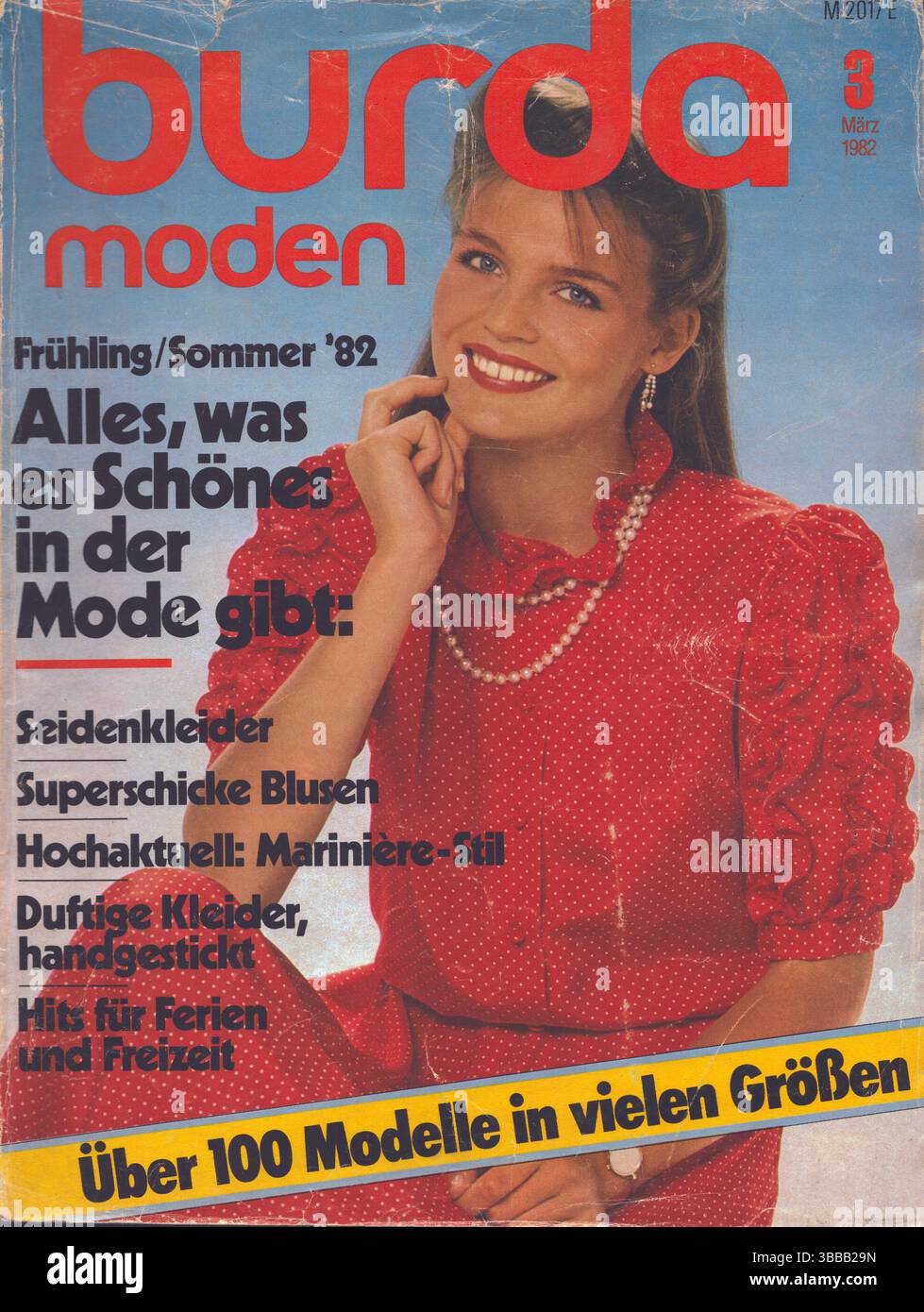Cover page of German Burda magazine, March 1982, Burda Moden vintage German fashion magazine, woman in red polka dot shirt Stock Photo