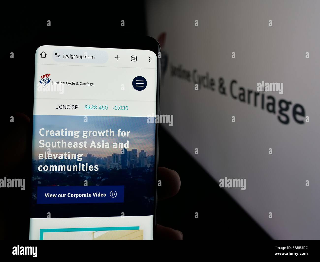 Stuttgart, Germany - 01-03-2024: Person holding smartphone with webpage of Singaporean company Jardine Cycle Carriage Limited on screen with logo. Stock Photo