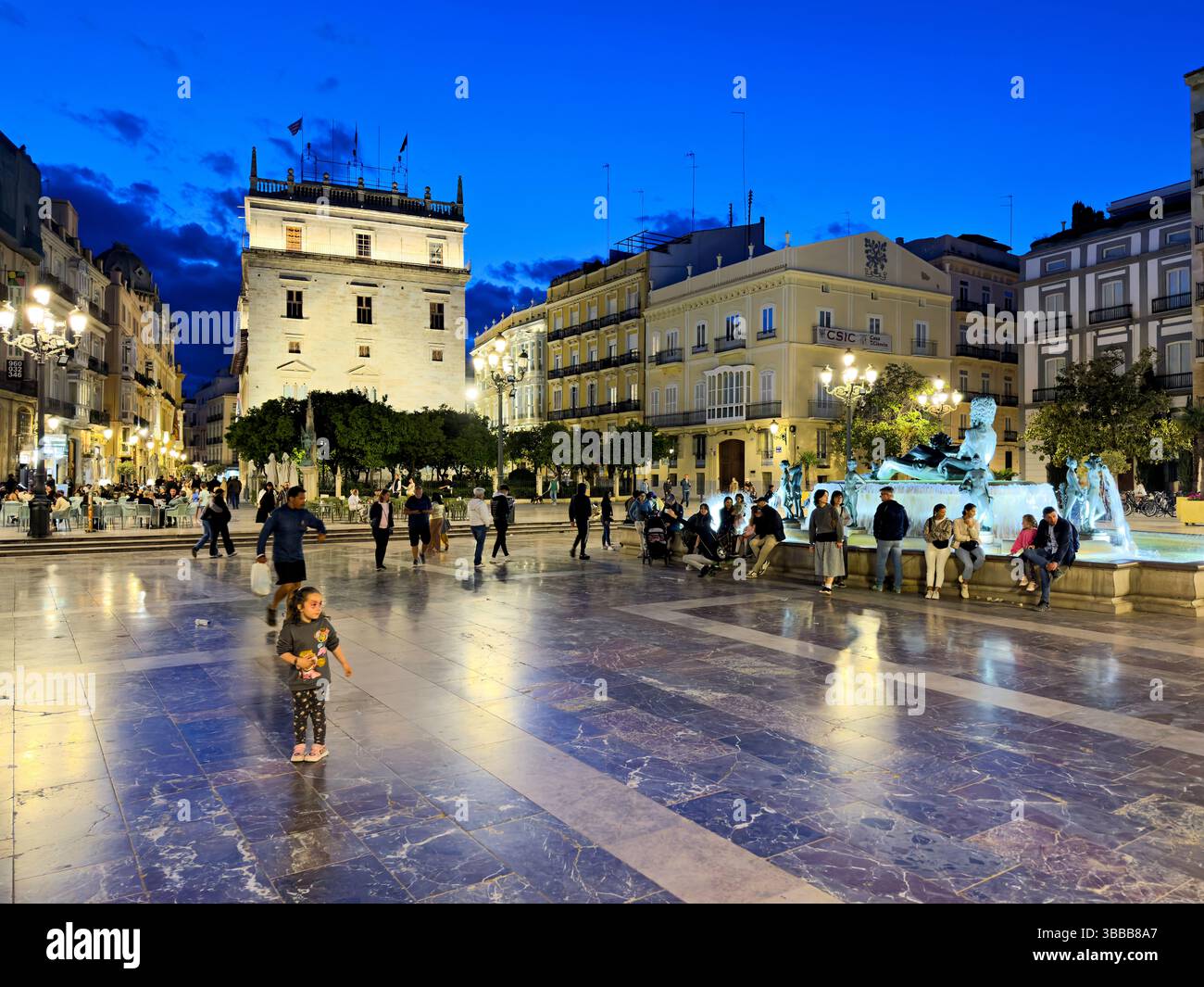 Plaza del Ayuntamiento Valencia at dusk with people enjoying the evening atmosphere Stock Photo