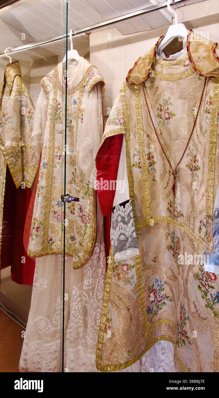 Collection of chasubles worn by priests for mass in a display case in the iglesia de San Martín Plaza Mayor Trujillo Caceres Extremadura Spain Europe Stock Photo