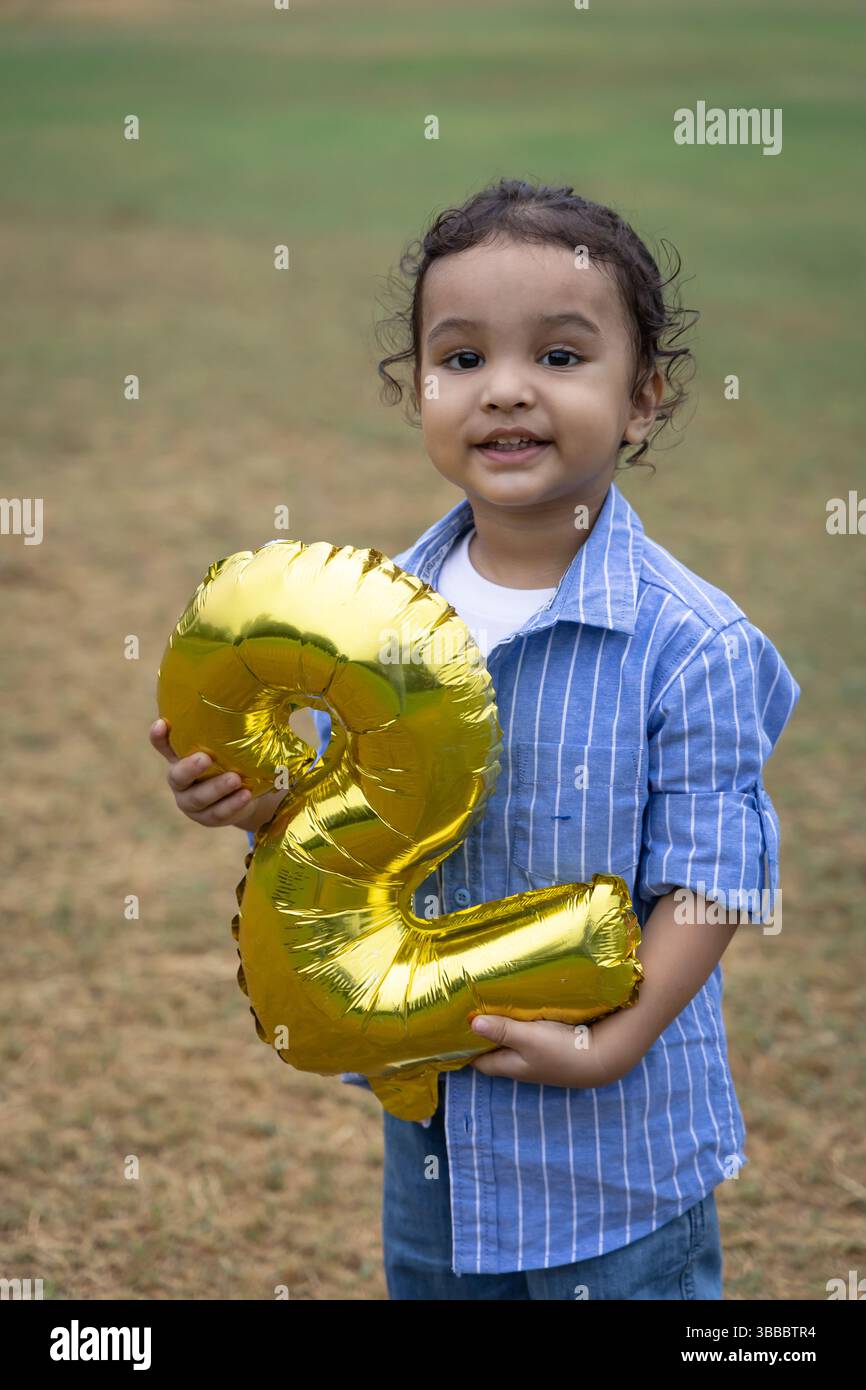 indian toddler playing with object with cute facial expression at ...