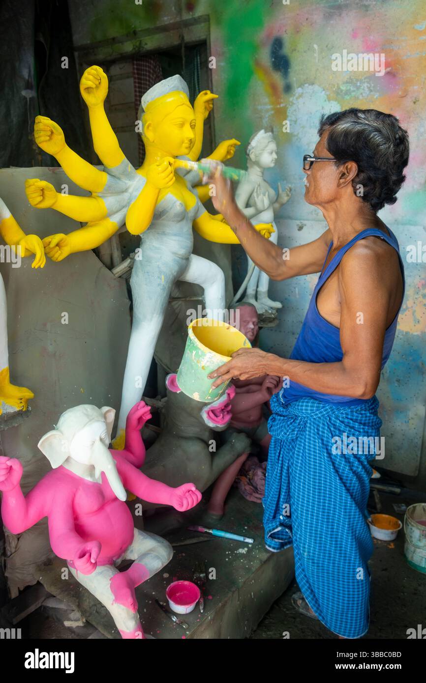 a craftsman put finishing touches on straw and clay statue of goddess Durga, Kumartuli district, during the Durga Puja festival, Kolkata, Calcutta, Stock Photo