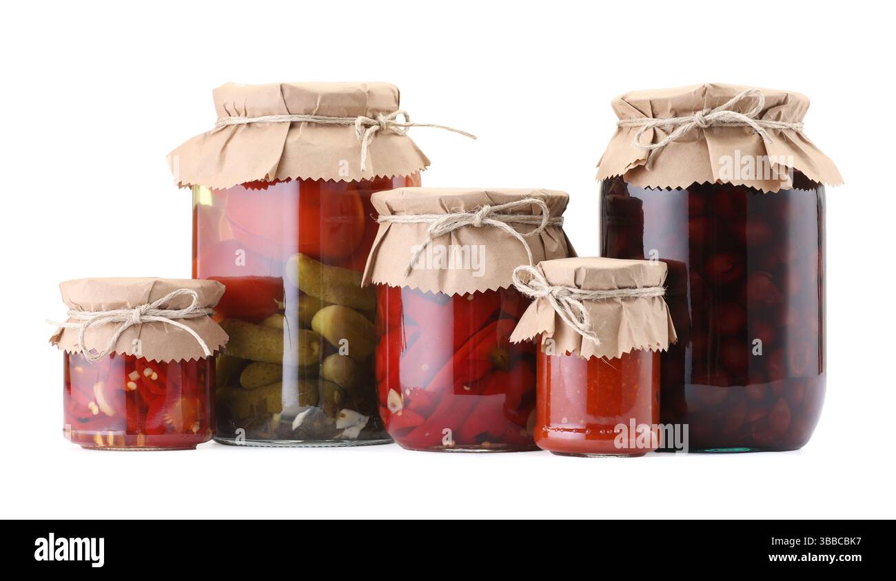 Many jars with different pickled products isolated on white Stock Photo