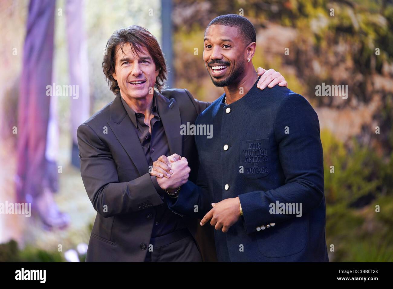Tom Cruise, left, and Michael B. Jordan pose for photographers upon