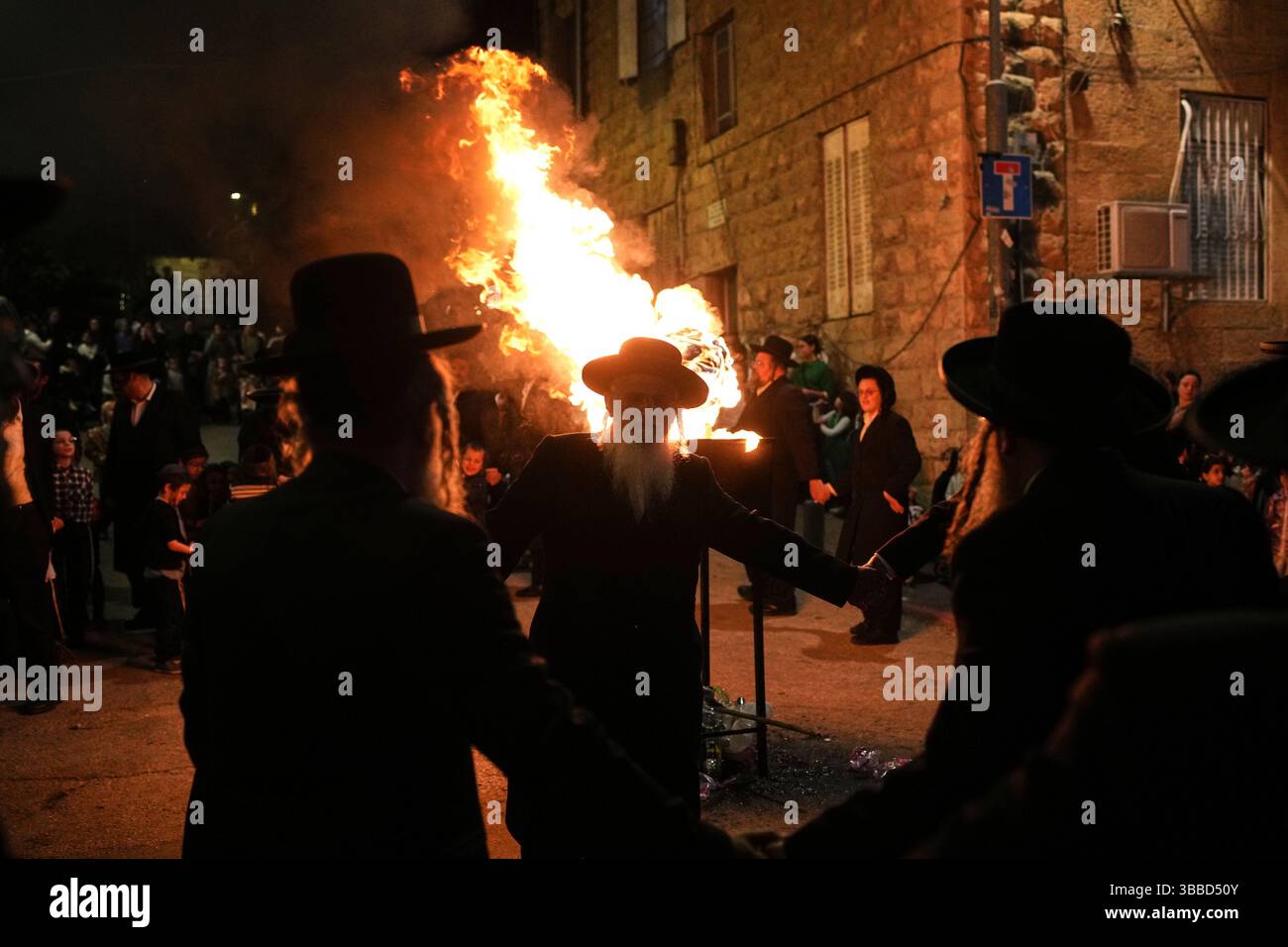UltraOrthodox Jews dance around a bonfire during Lag BaOmer