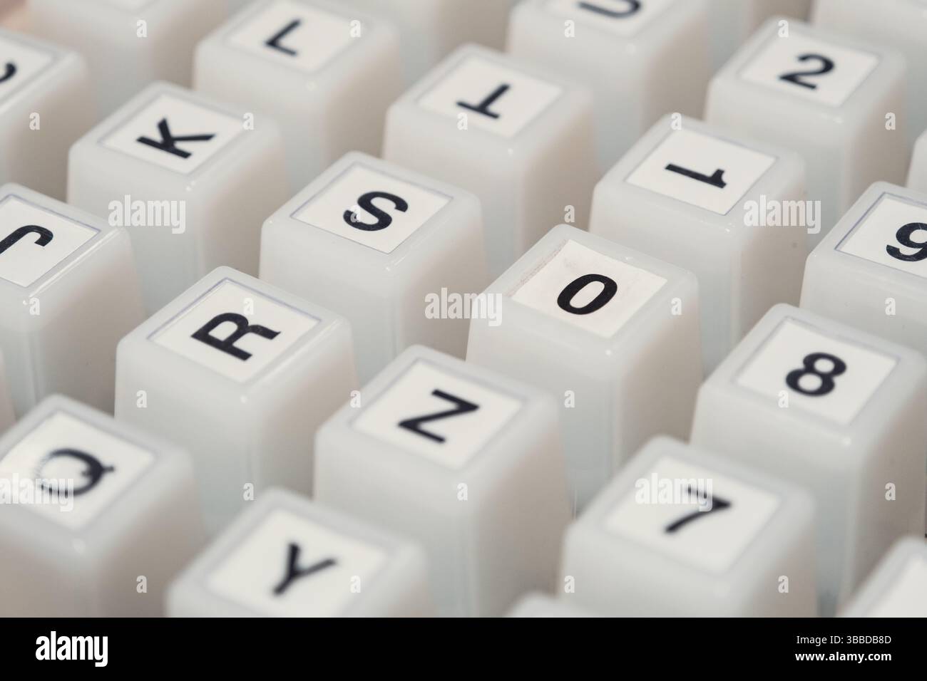 Close-up of white keyboard keycaps with letters, numbers, and symbols Stock Photo