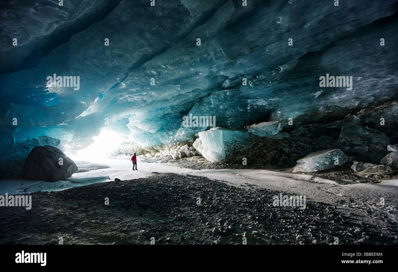 Hiker Walking Through Morteratsch Glacier Ice Caves Switzerland hiker-walking-through-morteratsch-glacier-ice-caves-switzerland