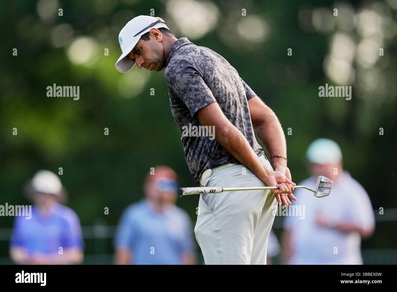 Aaron Rai, of England, lines up a putt on the ninth hole during the ...