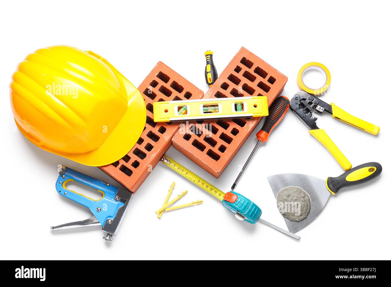 Hardhat, bricks and construction tools on white background Stock Photo